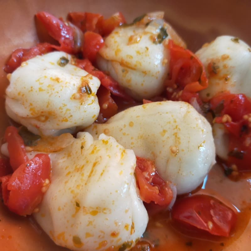 Culurgiones with their wheat-ear seam, served in tomato sauce