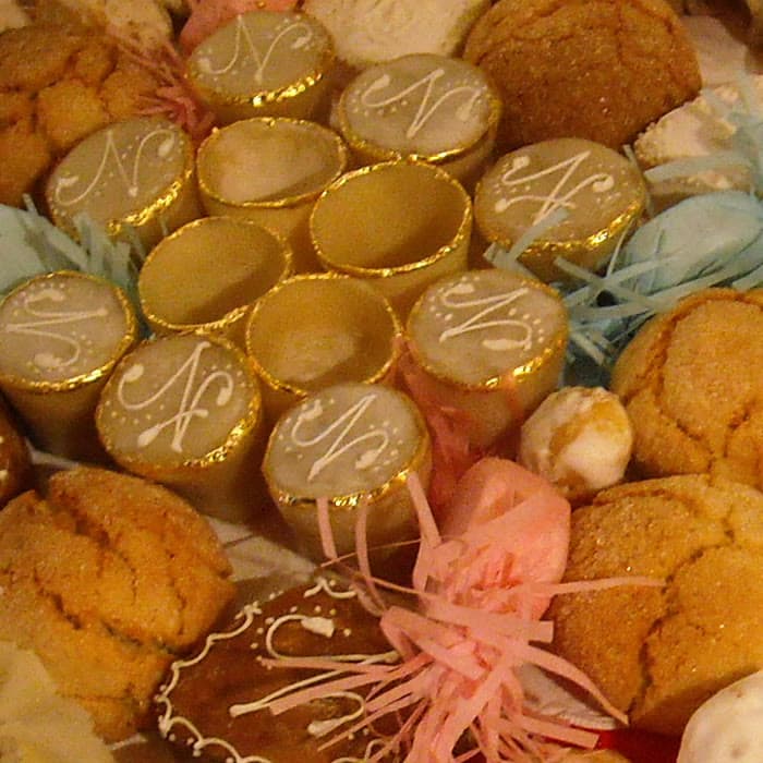A tray of Sardinian celebration sweets, glazed and piped with white initials