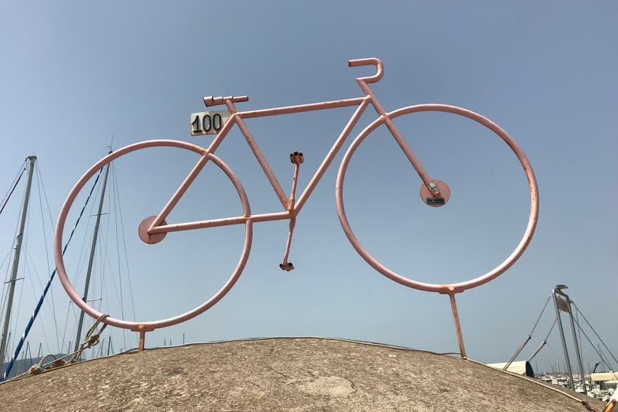 A pink sculpted bicycle marked 100 in Alghero, put up for the centenary Giro d'Italia.